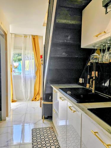 a kitchen with a staircase leading to a room at Maison Romantique entre deux fleuves chez l'habitant in Montereau-Fault-Yonne