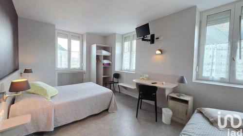 a bedroom with a bed and a desk and a sink at Au bon saint Nicolas in Hillion