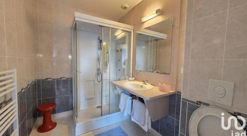 a bathroom with a sink and a shower and a toilet at Au bon saint Nicolas in Hillion