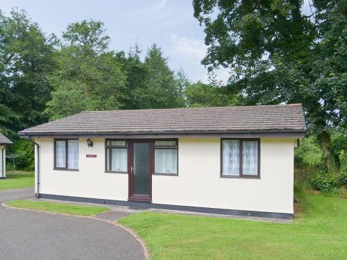 a small white house with a brown roof at Trebah - B5623 in Saint Cleer