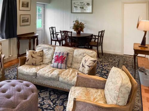 a living room with a couch and a table at The Library - Uk46649 in Crickhowell