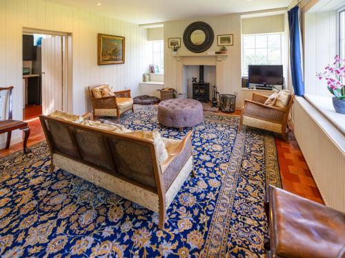 a living room with a couch and chairs on a rug at The Library - Uk46649 in Crickhowell
