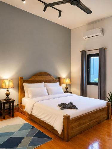 a bedroom with a large bed with a hat on it at Casa Primera in Luang Prabang