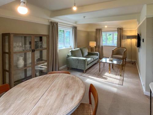 a living room with a table and a couch at Pine View - Uk50699 in St Margarets at Cliff
