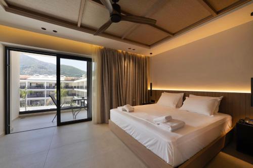 a bedroom with a large bed and a large window at La Finestra in Nydri