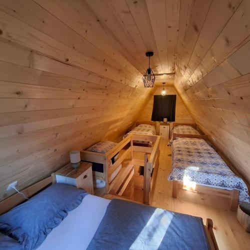 a bedroom in a log cabin with two beds at Vikendica Breza 2 in Zaovine
