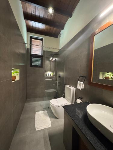 a bathroom with a toilet and a sink at Foresta Resort Sigiriya in Sigiriya