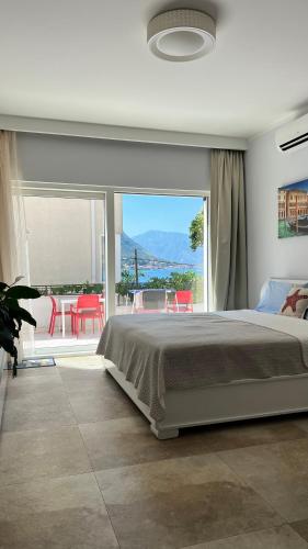 a bedroom with a bed and a view of a patio at Melodia del Mare in Kotor
