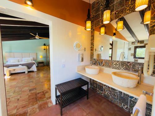 a bathroom with two sinks and a large mirror at Secrets Rural House in Jávea