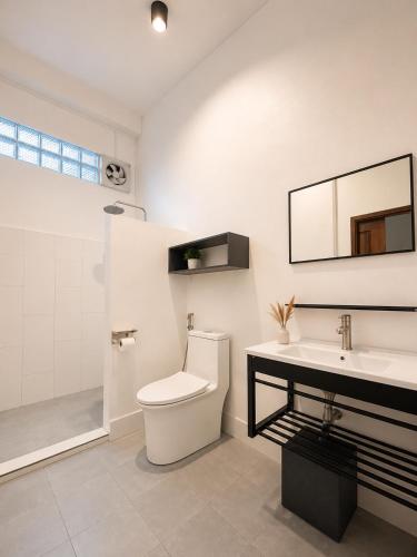 a bathroom with a toilet and a sink and a shower at Primera Vacation Home in Luang Prabang