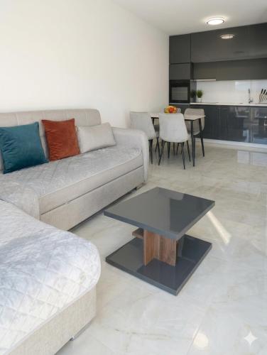 a living room with a couch and a table at Apartman SOFI in Ulcinj