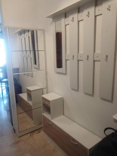 a bathroom with white cabinets and a large mirror at appartamento 4 piano in Chioggia