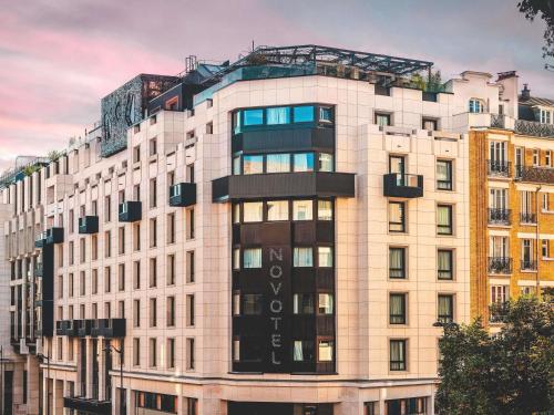 a tall building with a sign on top of it at Novotel Paris Vaugirard Montparnasse in Paris