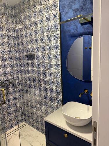 a bathroom with a sink and a shower at Aqua Azzuro Lovran in Lovran