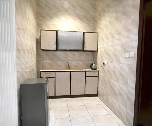a bathroom with a sink and a mirror at شقق شاطئ الواحة in Jeddah