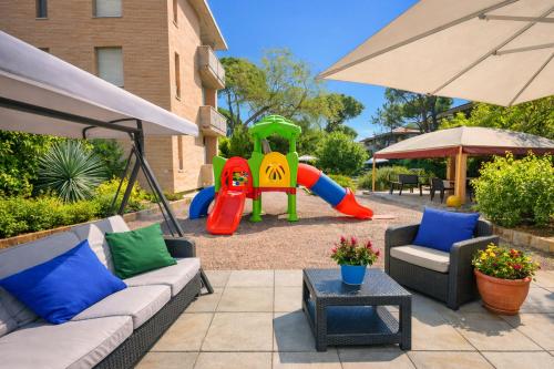 a backyard with a playground with a slide at Residence Casa Pineta in Principina a Mare