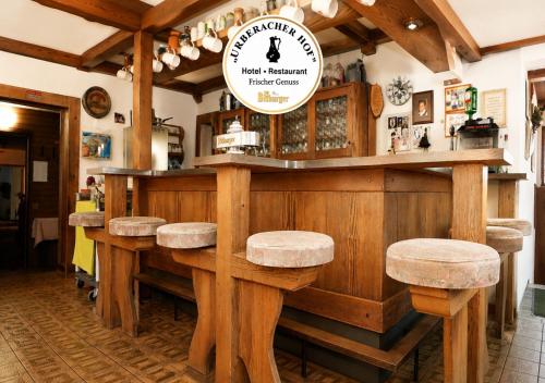 a wooden bar with stools in a restaurant at Urberacher Hof in Rödermark