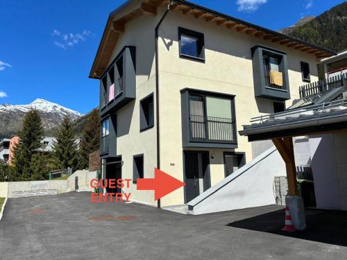 a building with a red arrow pointing to a guest apartment at Mountain spot in a cozy nest in Airolo