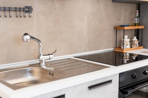 a kitchen with a stainless steel sink and a counter at La Casetta al mare in Balestrate