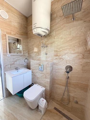 a bathroom with a toilet and a sink at Duraku Apartments in Ulcinj