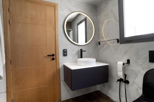 a bathroom with a sink and a mirror at flora bay luxe in Agadir