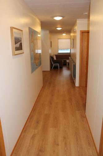 an empty hallway of a hospital room with a couch at Ormurinn Guesthouse in Egilsstadir