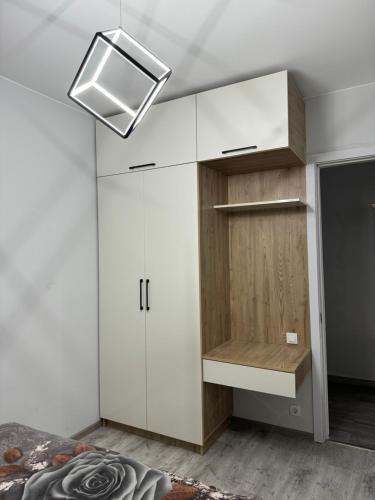 a room with a white cabinet and a tv at Ideal home in Minda