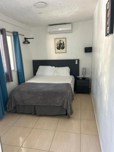 a bedroom with a large bed in a room at Hotel HILLMON in Sosúa