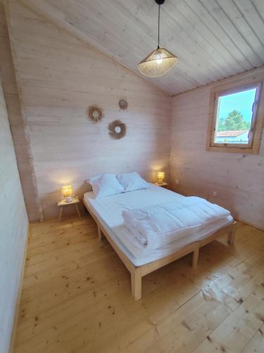 a bedroom with a large bed in a attic at Le chalet d'Agathe in Largentière
