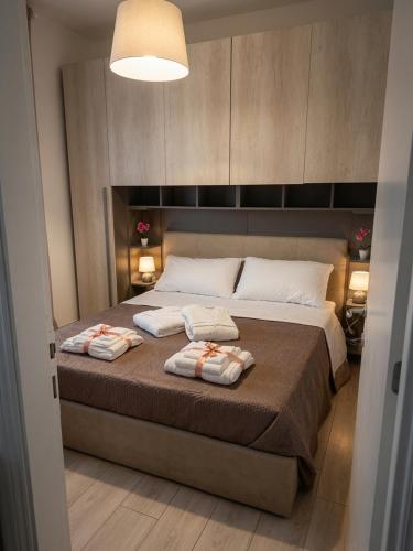 a bedroom with a large bed with two towels on it at Casa Paloma Free Parking in Bolsena