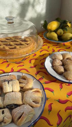 a table topped with plates of pastries and a pie at Il borgo di Iaconti in Vietri sul Mare