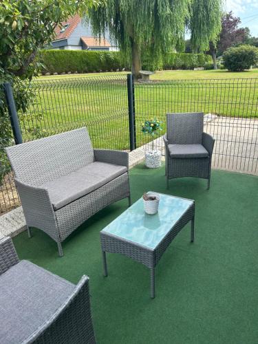 a patio with two chairs and a table and a couch at Joe bar stud in Gonnetot