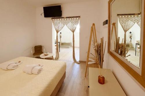 a bedroom with a bed and a large mirror at Rhodes Beach Side Houses in Ixia