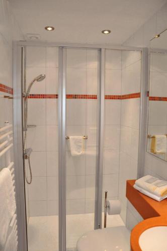 a bathroom with a shower and a sink at Hotel Haus am Hochwald in Hahnenklee-Bockswiese