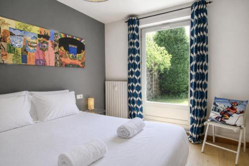a bedroom with a white bed and a window at Apartment Picasso in Chamonix