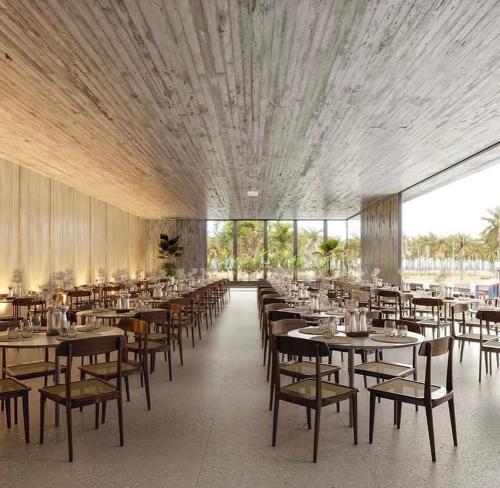 a dining room with tables and chairs in a building at Gav resort beach in Salinópolis