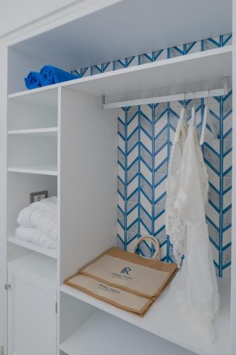 a white closet with a box on a shelf at Milky Suites Positano in Positano