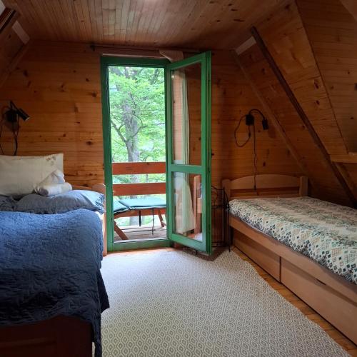a bedroom with two beds and a window at Vikendica Breza in Zaovine