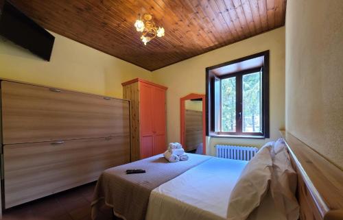 a bedroom with a bed with a teddy bear on it at La Pinetina in San Massimo