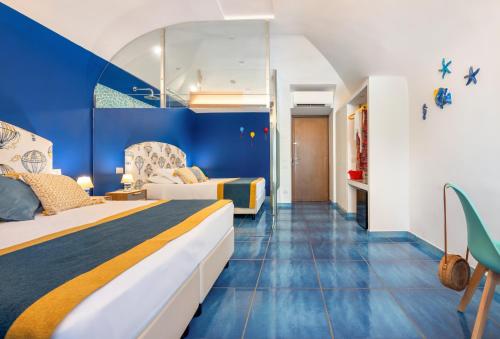 a hotel room with a bed and a blue wall at Aquae Romanae in Sorrento