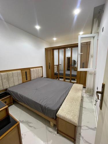 a bedroom with a large bed and a window at Nesma Douaouda in Douaouda