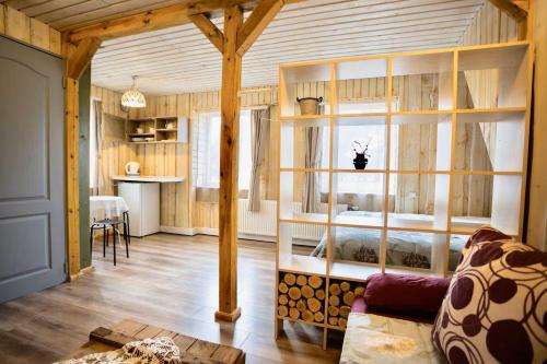 a living room with a large room with wooden walls at Šķilas in Pērkone