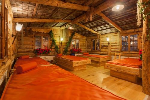 a room with four beds in a log cabin at Alpinhotel Berghaus spa in Tux