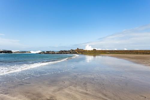 a beach with the ocean and a house in the background at Don Rafael # Ocean views # Natural pools in Bajamar