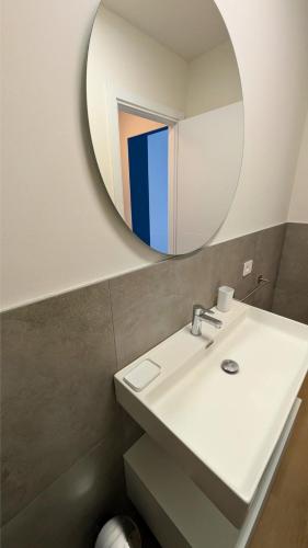 a bathroom with a sink and a mirror at Sfreg Suites Magenta - Camere e B&B in Magenta