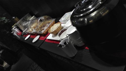 a table with pastries and a coffee machine on it at Rotermanni Guest Apartments in Tallinn