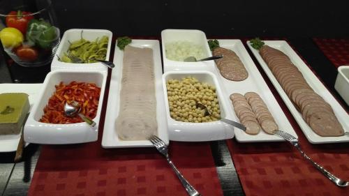 a table topped with trays of food on a table at Rotermanni Guest Apartments in Tallinn