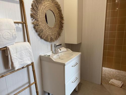 a bathroom with a sink and a mirror on the wall at Acadie Saint Victor - Hôtel restaurant -Face mer- Châtelaillon plage in Châtelaillon-Plage