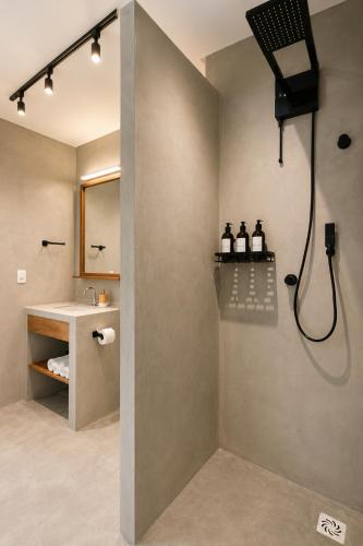 a bathroom with a shower and a sink at Luau Hotel in Flecheiras