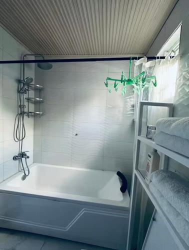 a white bath tub in a bathroom with towels at PENTHOUSE MPINGA RIMWEe in Kigali